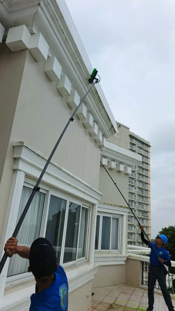 TopMop crew cleaning exterior surfaces with telescopic poles