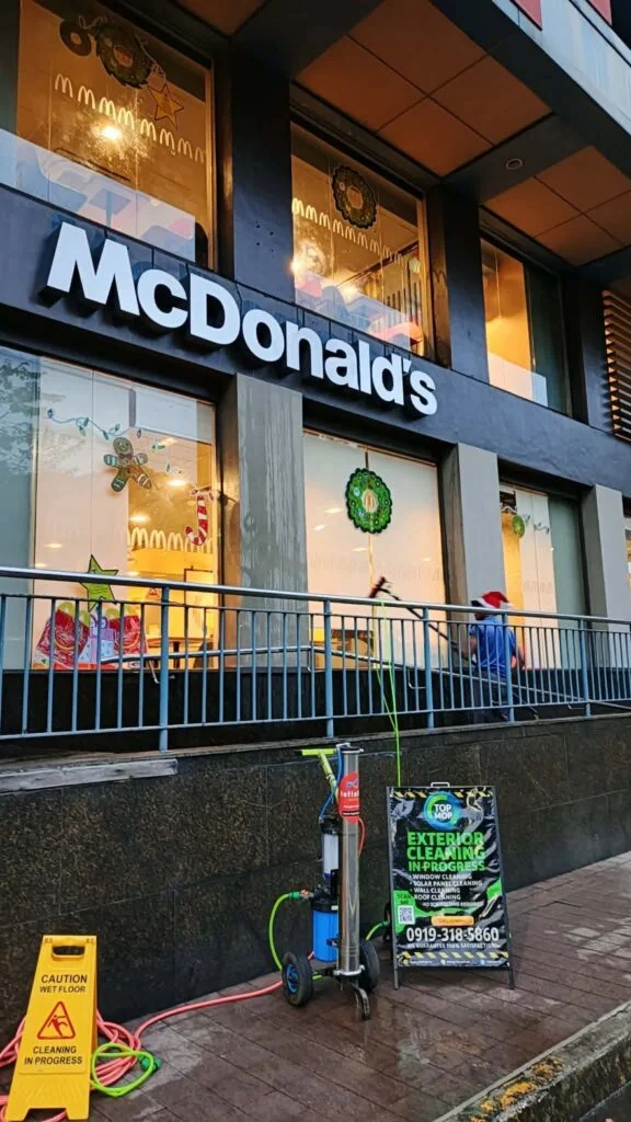 TopMop filtration equipment and cleaning signage outside a McDonald’s restaurant