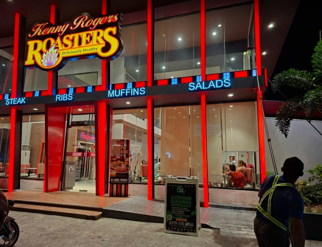 TopMop crew using a telescopic pole at the Kenny Rogers Bacao glass facade