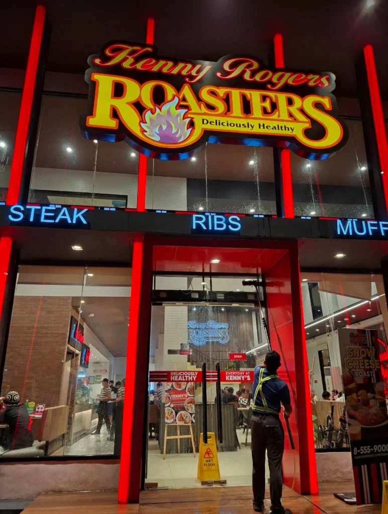 TopMop crew cleaning entrance glass at Kenny Rogers Bacao